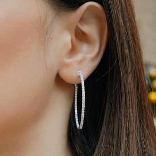 White gold hoop earrings feature 2.11 ct. lab grown diamonds with a diamond clarity of VS1
