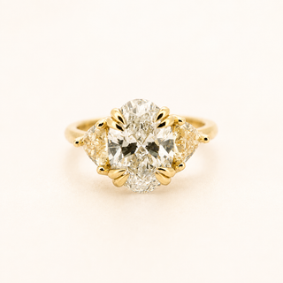A - 3 ct Oval Cut Ring with Fancy Yellow Trillion Cut Diamonds