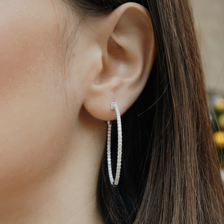 White gold hoop earrings feature 2.11 ct. lab grown diamonds with a diamond clarity of VS1